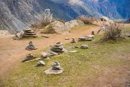 Sacred mountain site with white ribbons on tree and stone cairns near Katu Yaryk pass in Altai Russia Spiritual place of worship in remote highlands. High quality photoの写真素材