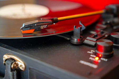 Close-up of record player needle tracking vinyl grooves during playback. Analog sound detail capturing retro music atmosphere. High quality photoの写真素材