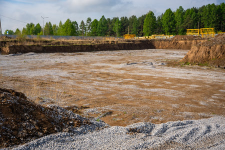 Cleared construction site prepared for building foundation. Excavation area ready for new...