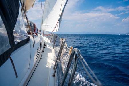Side of a sailing yacht cutting through the sea with full sails near Croatia. Motion, freedom,...