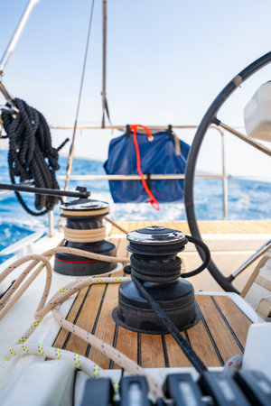 Cockpit of a sailing yacht with steering wheel, winches and ropes during navigation near Croatia. Sailing equipment, control and lifestyle at sea. High quality photoの写真素材