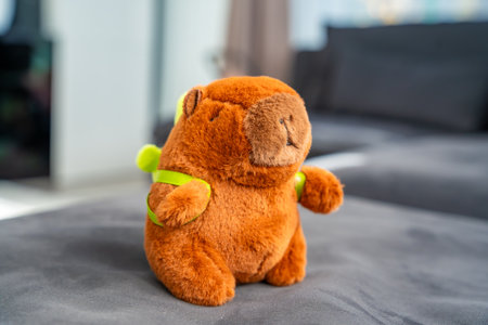 Close-up of a plush capybara toy isolated on a soft surface. Aesthetic representation of Gen Z...