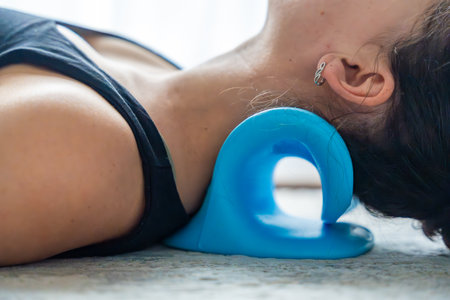 Close-up of blue cervical traction device for neck stretching and spine decompression. Non-electric tool used at home for pain relief and posture correction.の写真素材