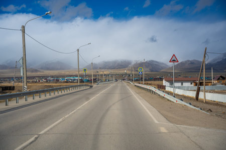 Kosh-Agach, Russia - May 8, 2025: Streets, houses, and road in Kosh-Agach Altai Russia. Urban landscape of a remote Siberian mountain townのeditorial素材