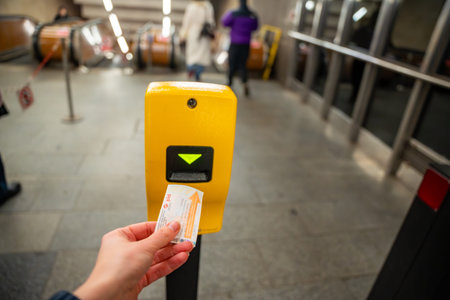 Prague, Czech republic - January 16, 2026: Passenger validating PID public transport ticket in Prague metro station. Urban transportation system and daily commuting in Czech Republicのeditorial素材