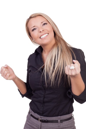 Woman looking to heaven for help with her fists clenched and a beseeching look in her eyes as she waits for a decision or outcome that will affect her, half body portrait isolated on whiteの写真素材