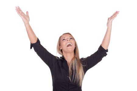 Joyful vivacious blonde woman laughing with her outstretched arms raised to the sky, upper body studio portrait isolated on whiteの写真素材