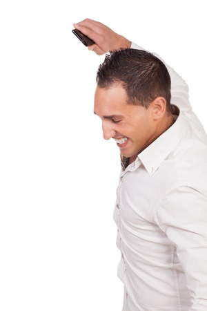 Jubilant handsome young man rejoicing at good news that he just received over his mobile phone , closeup half body studio portrait isolated on white with copyspaceの写真素材