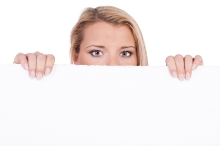 Insecure woman protrudes behind empty white boardの写真素材