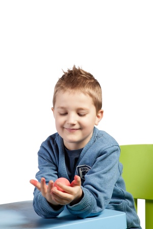 A cute little boy admiring his painted Easter eggの写真素材