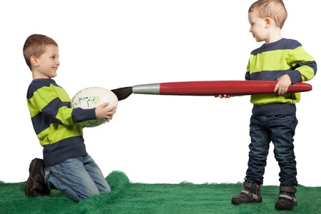 Easter theme with two young boys decorating a big egg with an oversized paint brush for Easter の写真素材