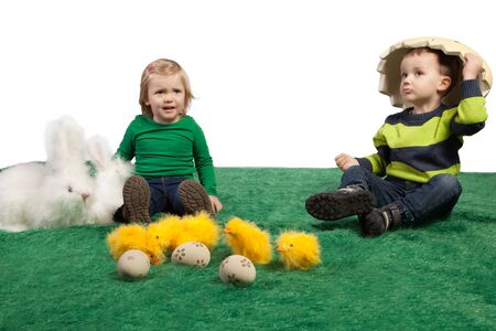 Easter theme with cute small girl and boy with toy bunnies, chicks and eggs の写真素材