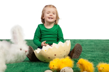 Easter theme with cute young girl smiling at the camera with toy bunny, chicks and eggs の写真素材