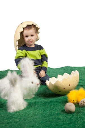 Easter theme with small boy with toy bunnies, chicks and eggsの写真素材