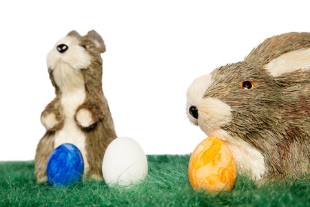 Two Easter bunnies and painted Easter eggs on green grassの写真素材