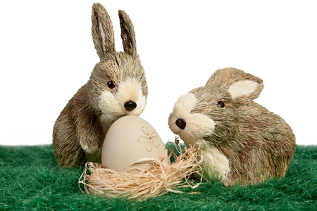 Easter theme with two ornament rabbits with egg in a nest の写真素材