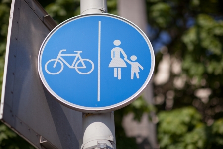 Road sign for bicycles and pedestrians showing that a particular track or lane is restricted from use by vehiclesの写真素材