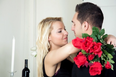 Love - a beautiful tender moment between a young man and his pretty blond girlfriend as she accepts his proposal for her hand in marriageの写真素材