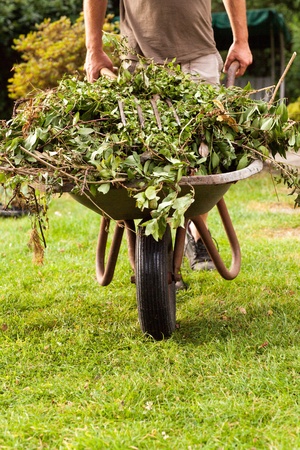 The gardener is banking the barrow over the grasland の写真素材