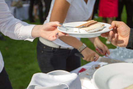 Two people are fighting for the last piece of the wedding cake の写真素材
