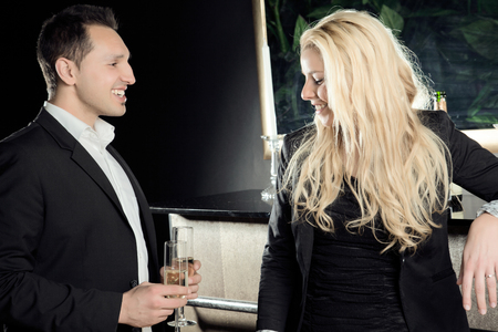 A young man flirts with a cute blond lady の写真素材