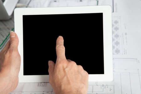 A gesture on a Tablet PC with one Finger in a vertical position.の写真素材