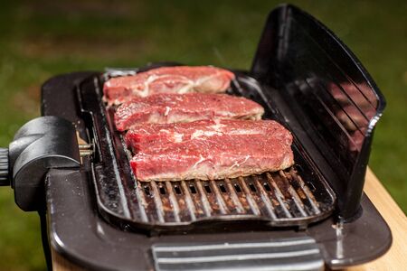Four Steaks on a electric Grill.の写真素材