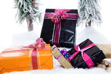 A couple of Christmas Presents in a snowy winter landscape の写真素材