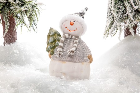A Snowman in the mittle of a snowy forest の写真素材