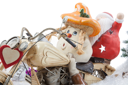 A cartoon Mushroom together wit Santa Claus on a Motorcycle within a snowy winter Scenery の写真素材
