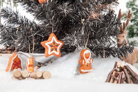 A Reindeer is watching trough a christmas Tree in a bright winter Scenery の写真素材