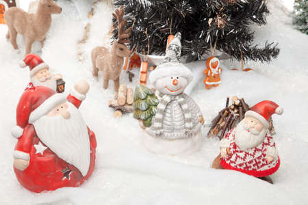 Santa Claus is doing a meeting before Christmas starts  Reindeers, a snowman and some other Santa Clauses are involved の写真素材