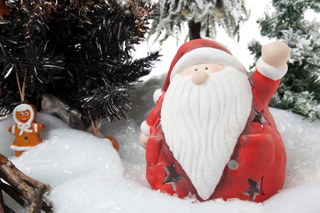 Santa Claus wishes you a merry christmas in a snowy winter Scene の写真素材