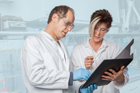 The Chemist Professor is explaining some Test Results to his assistant の写真素材