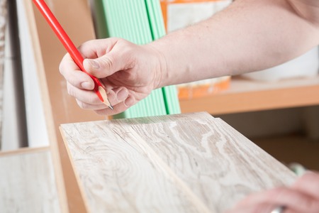 The Carpenter is drawing a line on the laminate.の写真素材