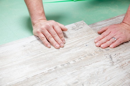 A man verifies if two piece of laminate has the same width.の写真素材