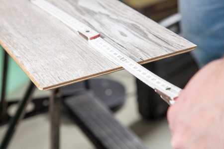 A Carpenter is measuring the laminate の写真素材