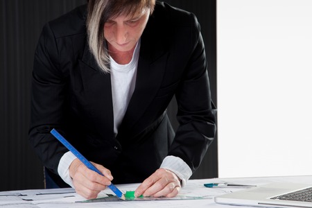 An Architect is drawing a construction plan の写真素材