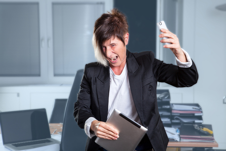 A manager is crying and shouting in her Office の写真素材