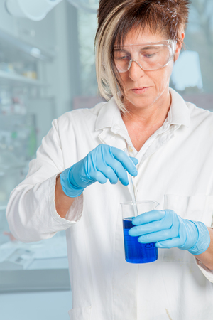 A Assistant is doing a boring Laboratory job の写真素材