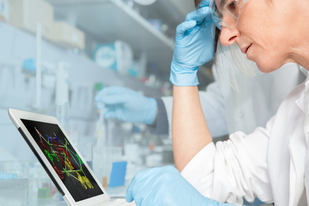A Chemist Trainee is studying an atomical structure in the Laboratory for her examination の写真素材