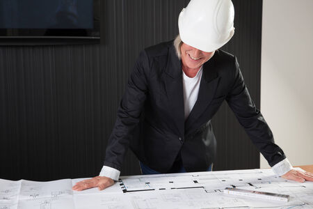 Architect looking at the construction planの写真素材
