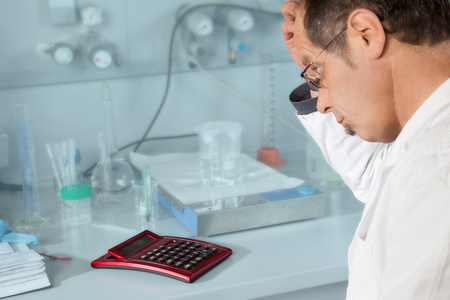 A Chemist is pondering if the calculation is right の写真素材