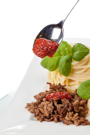 Some roasted minced meat with spaghetti and basil の写真素材