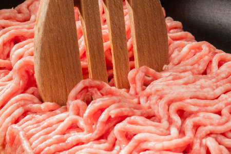 A extreme closeup shot from a piece of minced meat in a pan の写真素材