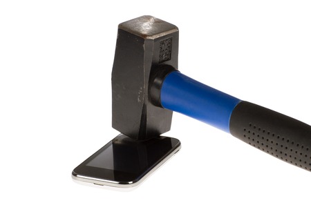 A cellular phone a step before destroyed by a hammer の写真素材