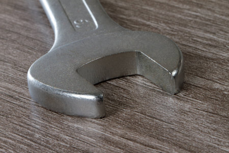 A closeup from a combination wrench on a wooden floor の写真素材