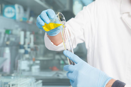 A Professor is preparing a chemical yellow liquid mix の写真素材