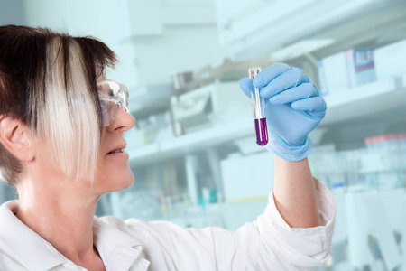 A doctor is checking the liquid in the test tube の写真素材