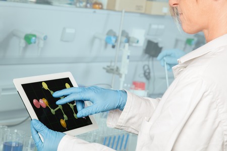 A Professor is using a two finger gesture to scroll through the molecular structure の写真素材